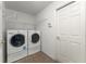 The laundry room features a washer, dryer, and wire shelving for storage at 351 Cloverdale Rd, Winter Haven, FL 33884