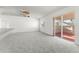 Spacious living room with neutral carpet and sliding glass door to patio at 351 Cloverdale Rd, Winter Haven, FL 33884