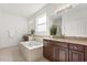 Large primary bath featuring a soaking tub, dual vanities, and granite countertops at 3868 Whitewood Ct, Oviedo, FL 32766