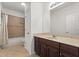 Bathroom featuring a dark wood vanity with a cream-colored countertop and shower at 3868 Whitewood Ct, Oviedo, FL 32766