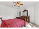 Bedroom with red bedspread, carpeted floors and a ceiling fan at 3868 Whitewood Ct, Oviedo, FL 32766