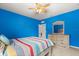 Bedroom with bright blue walls, ceiling fan and neutral colored carpeting at 3868 Whitewood Ct, Oviedo, FL 32766