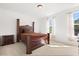 Bright bedroom featuring a plush carpet, elegant bed, and sunlit windows at 3868 Whitewood Ct, Oviedo, FL 32766