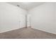 Bedroom with neutral carpet, white walls, and a doorway to a light-filled room at 3868 Whitewood Ct, Oviedo, FL 32766