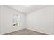 A clean bedroom with neutral carpet, a single window and white walls at 3868 Whitewood Ct, Oviedo, FL 32766