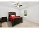 Bedroom featuring black wood bedframe, paneled door and plush carpeting at 3868 Whitewood Ct, Oviedo, FL 32766