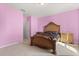Bedroom featuring pink walls, carpet flooring and decorative wood bedframe at 3868 Whitewood Ct, Oviedo, FL 32766