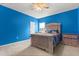 Bedroom featuring blue colored walls, carpeted floor and ceiling fan at 3868 Whitewood Ct, Oviedo, FL 32766
