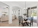 Dining room with modern chandelier and view of the pool area at 3868 Whitewood Ct, Oviedo, FL 32766