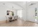 Elegant dining room featuring a modern chandelier, large windows, and stylish furniture at 3868 Whitewood Ct, Oviedo, FL 32766