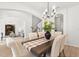 Open-concept dining area with stylish furniture and view to the living area and staircase at 3868 Whitewood Ct, Oviedo, FL 32766