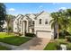 Attractive two-story home with a two-car garage, brick driveway, and well-kept landscaping at 3868 Whitewood Ct, Oviedo, FL 32766