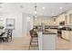 Open concept kitchen with stainless steel appliances and bar stool seating at 3868 Whitewood Ct, Oviedo, FL 32766