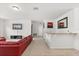 Comfortable living room featuring a red leather sectional sofa and bar area at 3868 Whitewood Ct, Oviedo, FL 32766
