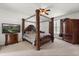 Elegant main bedroom featuring a carved four poster bed frame, and detailed furniture at 3868 Whitewood Ct, Oviedo, FL 32766
