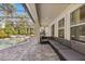 Covered patio featuring modern seating, a tiled floor, and access to the pool area at 3868 Whitewood Ct, Oviedo, FL 32766