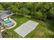 Aerial view of a volleyball court with sand, next to green space, fencing and walking path at 3868 Whitewood Ct, Oviedo, FL 32766