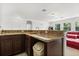 Wet bar featuring granite countertops and dark wood cabinets in the entertainment area at 3868 Whitewood Ct, Oviedo, FL 32766