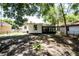 View of a backyard with the rear of the house featuring black framed windows and partial tree shade at 415 S Lancelot Ave, Orlando, FL 32835
