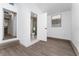 Bathroom featuring wood-look floors, toilet and shower behind an open door at 415 S Lancelot Ave, Orlando, FL 32835