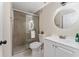 Bathroom featuring a modern vanity, round mirror, and glass-enclosed shower at 415 S Lancelot Ave, Orlando, FL 32835