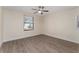 Bedroom featuring wood-look flooring, a window, and a ceiling fan at 415 S Lancelot Ave, Orlando, FL 32835