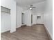 Spacious bedroom with wood-look floors, closet, and a doorway leading to a bathroom, perfect for relaxation at 415 S Lancelot Ave, Orlando, FL 32835