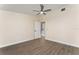 Bedroom featuring wood-look flooring, a ceiling fan, and an open door at 415 S Lancelot Ave, Orlando, FL 32835