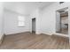 Light-filled bedroom with wood-look flooring, a walk-in closet, and a doorway to an adjoining room at 415 S Lancelot Ave, Orlando, FL 32835