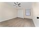 Bedroom featuring wood-look floors, closet, and a ceiling fan at 415 S Lancelot Ave, Orlando, FL 32835