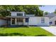 A modern house with a front porch, green lawn, and vibrant landscaping offers great curb appeal at 415 S Lancelot Ave, Orlando, FL 32835