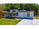 A well-maintained house boasts a green lawn, a covered porch, and a paved driveway for ease of parking at 415 S Lancelot Ave, Orlando, FL 32835