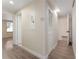 Hallway featuring wood-look flooring and multiple doorways at 415 S Lancelot Ave, Orlando, FL 32835