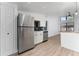 The kitchen has stainless steel appliances, a modern backsplash, and ample cabinet space for storage at 415 S Lancelot Ave, Orlando, FL 32835