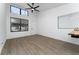 The room features ample natural light, neutral walls, wood-look floors, and a modern ceiling fan at 415 S Lancelot Ave, Orlando, FL 32835