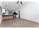 Open-concept living space with modern lighting, wood-look flooring, and white walls for a bright feel at 415 S Lancelot Ave, Orlando, FL 32835