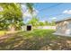 The home has a grassy backyard with mature trees and a storage shed at 4267 Kirkland Blvd, Orlando, FL 32811