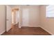 The bedroom has wood-look floors, a window with blinds, and a door leading to an adjoining bathroom at 4267 Kirkland Blvd, Orlando, FL 32811
