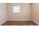 Bright bedroom features wood-look flooring and a window with mini blinds at 4267 Kirkland Blvd, Orlando, FL 32811