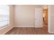 Bedroom featuring wood-look floors, neutral walls, and a door to the hallway at 4267 Kirkland Blvd, Orlando, FL 32811