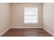 Bedroom features wood-look flooring and a window with mini blinds at 4267 Kirkland Blvd, Orlando, FL 32811