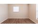 This cozy bedroom features wood-look floors and a window that provides natural light at 4267 Kirkland Blvd, Orlando, FL 32811