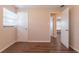 This bedroom features wood-look floors, a window with blinds, and a door to another room at 4267 Kirkland Blvd, Orlando, FL 32811