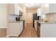 Galley kitchen with stainless steel appliances, granite countertops and white cabinetry at 4267 Kirkland Blvd, Orlando, FL 32811
