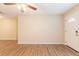 Bright living room with updated flooring, a ceiling fan, and a welcoming entry door at 4267 Kirkland Blvd, Orlando, FL 32811