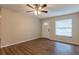 Inviting living room featuring a ceiling fan, hardwood floors, and a bright entry door at 4267 Kirkland Blvd, Orlando, FL 32811