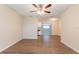 Spacious living room featuring wood flooring, a ceiling fan, and an open layout at 4267 Kirkland Blvd, Orlando, FL 32811