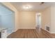 Open-concept living space with hardwood floors and a view into the adjacent room and kitchen area at 4267 Kirkland Blvd, Orlando, FL 32811