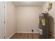 Compact utility room has modern water heater, and vinyl flooring at 4267 Kirkland Blvd, Orlando, FL 32811