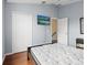 Bedroom featuring hardwood floors, a wall-mounted TV, a closet, and a door to the hallway at 437 Bridgewater Court, Kissimmee, FL 34758